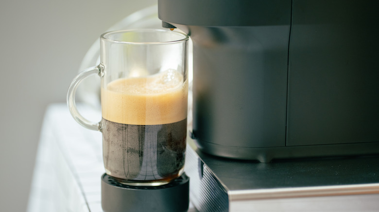 A Nespresso brewing a cup of coffee