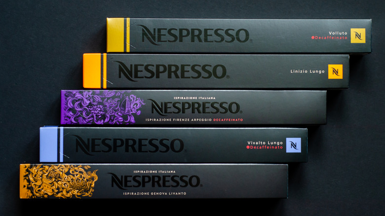 An order of several sleeves of Nespresso against a black background