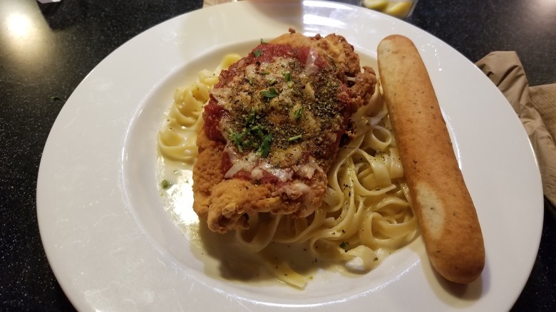 Applebee's pasta with breadstick on white plate