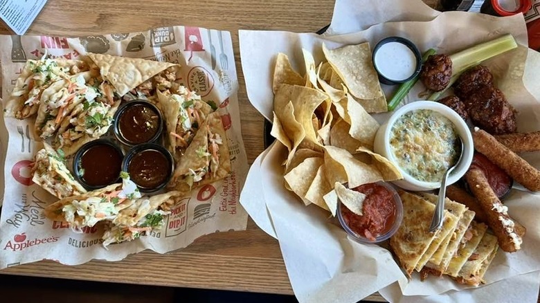 Two plates of food on wooden table at Applebee's