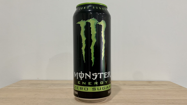 can of Monster Zero Sugar on wood table with white background