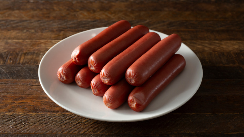 Pile of hot dogs on white plate