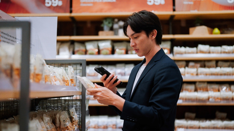 Customer scanning item on their phone at grocery store