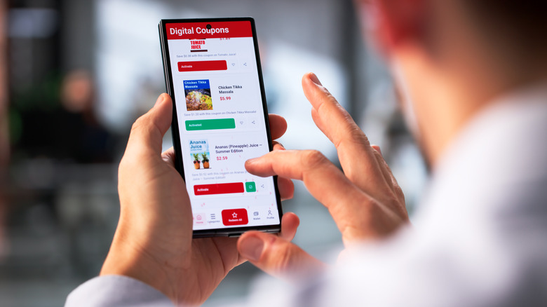 Person scrolling through digital coupons on phone