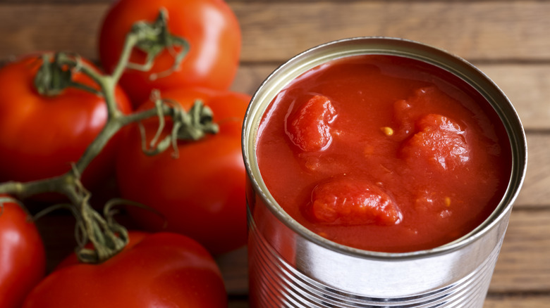 Open tin of chopped tomatoes with whole fresh tomatoes