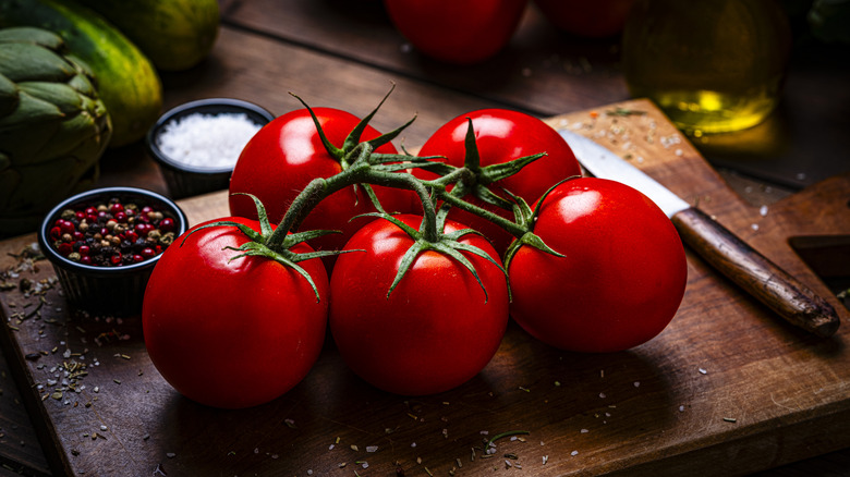 Ripe vine tomatoes on a wooden cutting board