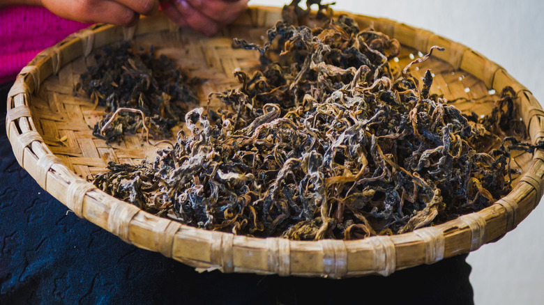 Basket of gundruk (traditional Nepali fermented leafy greens)