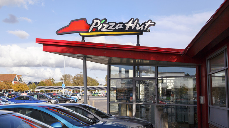 Pizza Hut sign over parking lot
