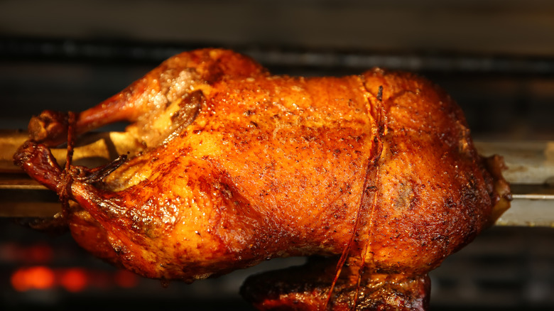 Close up of whole duck in rotisserie oven