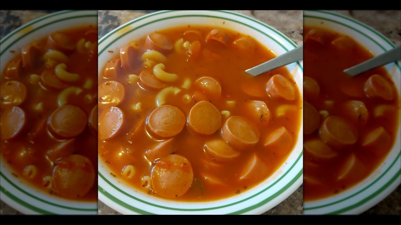 Mirrored image of hot dog tomato soup in a bowl