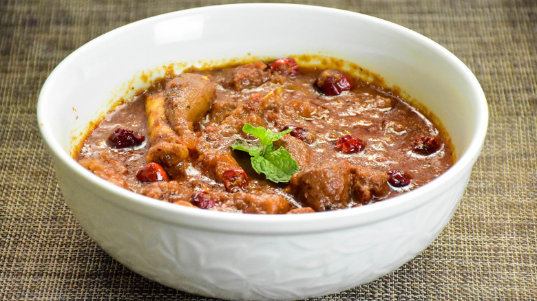 mutton stew in a white bowl with garnish