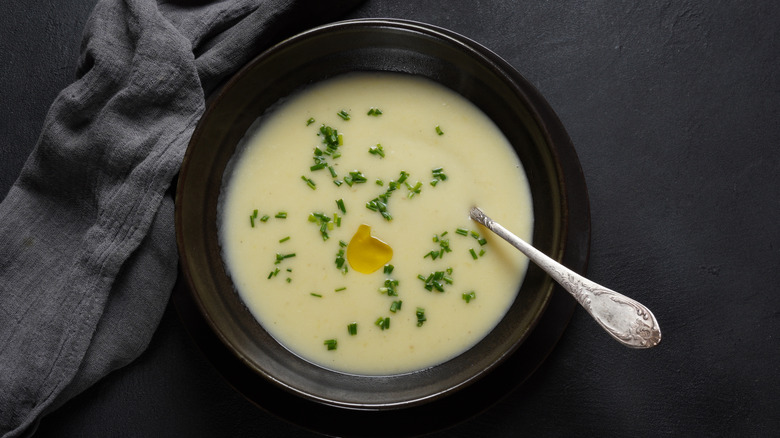black bowl of vichyssoise against dark background