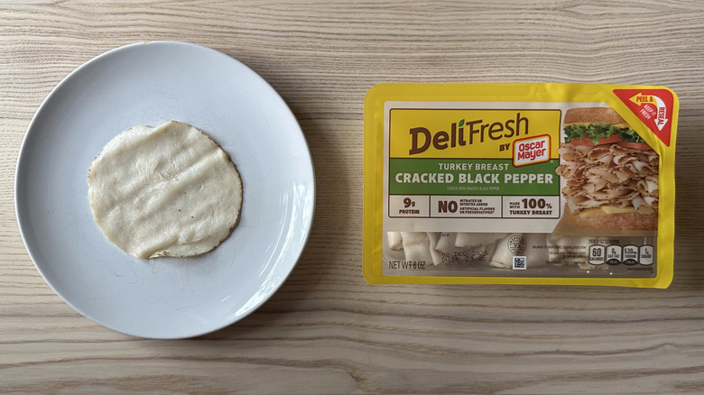 Deli Fresh Cracked Black Pepper Turkey Breast on wooden table