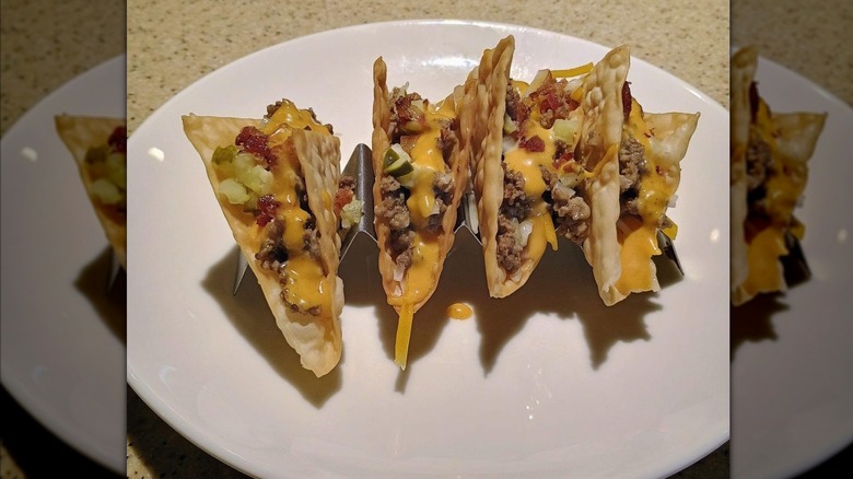 Mirrored image of Bacon Cheeseburger Wonton Tacos on white plate