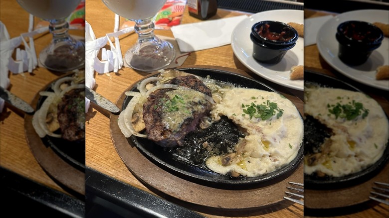 half-eaten Bourbon Street Steak in cast iron plate on messy restaurant table, mirrored image