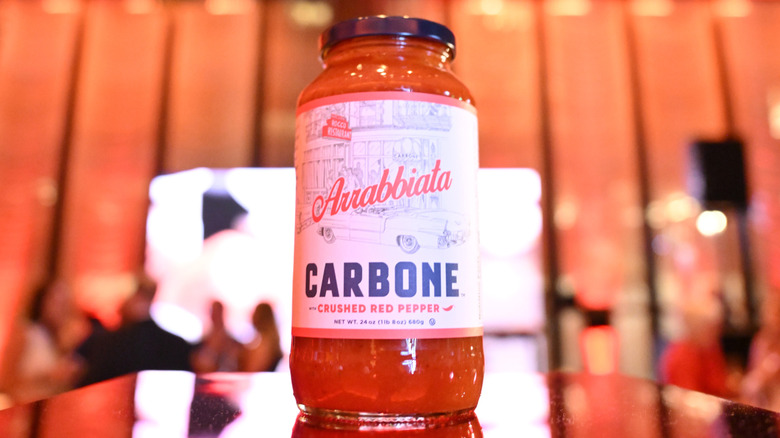 Jar of Carbone arrabbiata sauce on pedestal in showroom