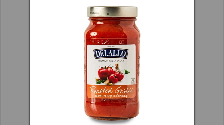 Jar of DeLallo roasted garlic pasta sauce with illustration of tomatoes and herbs on label