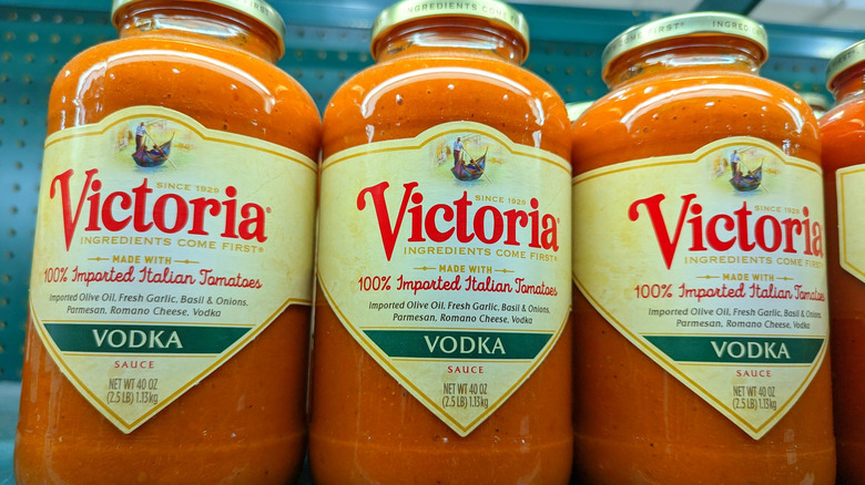 Several jars of Victoria vodka sauce on grocery store shelf