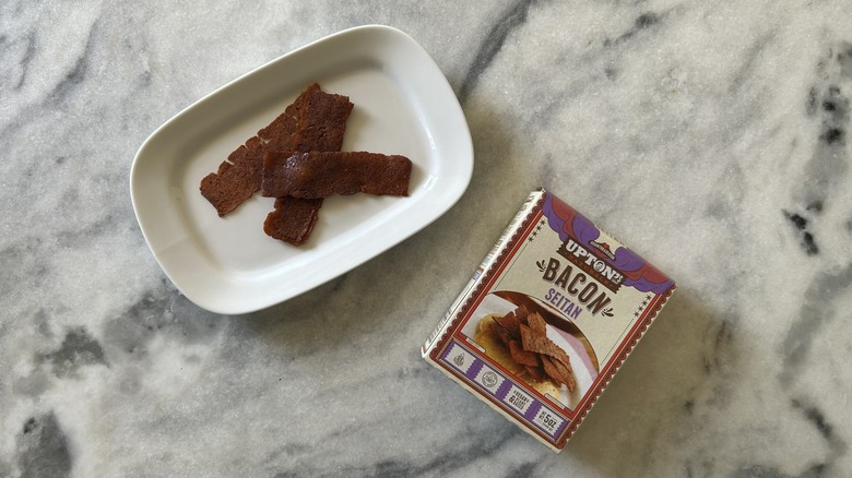 Seitan bacon next to an Upton's Naturals package