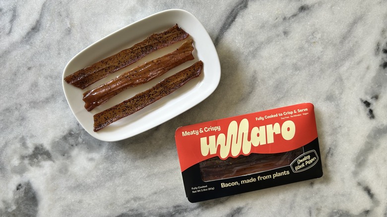 Peppery strips of vegan bacon next to an Umaro package