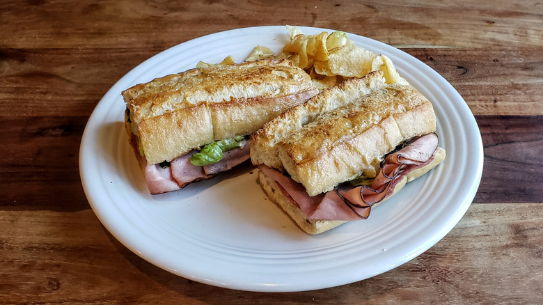 Panera bread's Toasted Italiano, plated, on a wood table.