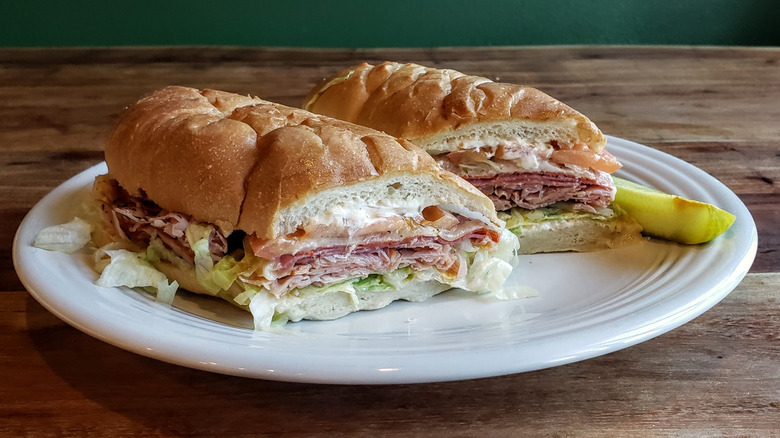Firehouse Sub's Italian Sub, plated, on a wood table.