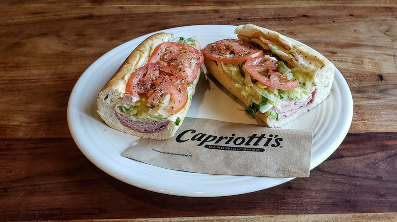 Capriotti's Classic Italian Sub, plated, on a wood table.