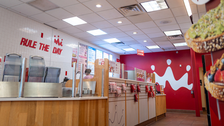 Interior of Smoothie King shop, showing ordering counter and advertisement for toasts