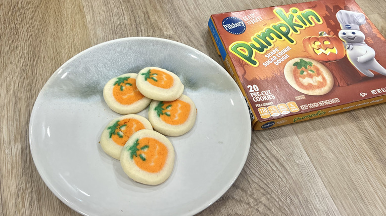 Pillsbury pumpkin shape sugar cookies on a plate.
