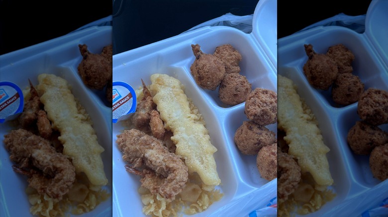 Captain D's hush puppies alongside fried fish on styrofoam tray