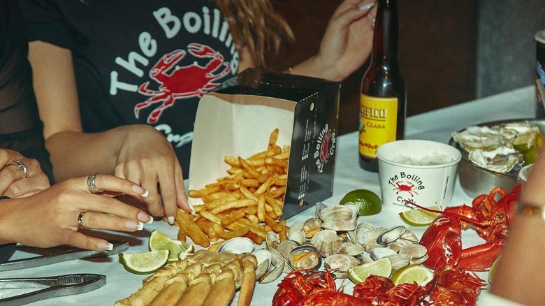 Cajun fries on a table with various types of seafood at The Boiling Crab