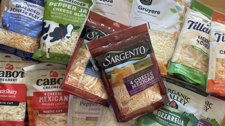 Variety of shredded cheese bags on wooden table