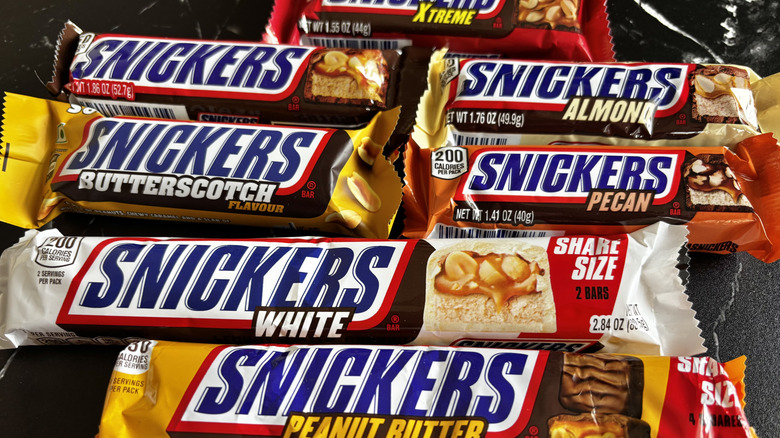 Various Snickers candy bars on countertop
