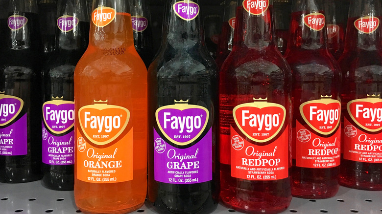 Grocery store shelf filled with bottles of Faygo soda
