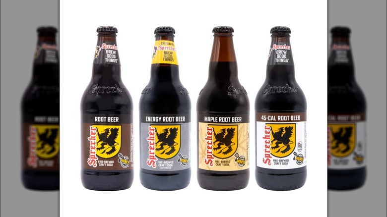 Four assorted bottles of Sprecher Fire-Brewed Root Beer sodas against a white background