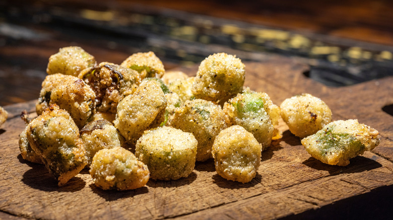 Deep fried slices of okra on a cutting board