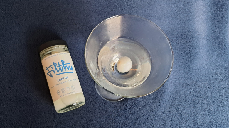 martini glass with cocktail onions