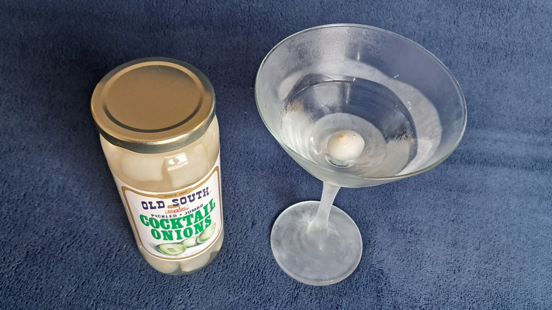 martini glass with cocktail onions