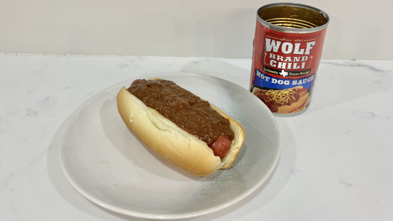 Wolf Brand Chili hot dog sauce on hot dog.