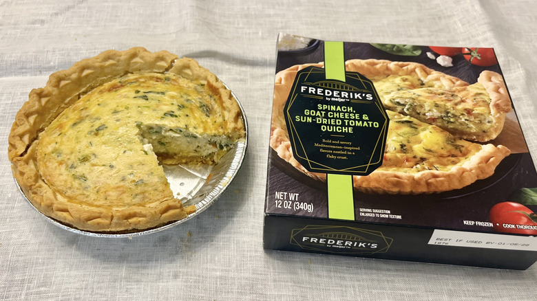 Meijer spinach, goat cheese, and sun-dried tomato quiche with slice missing.