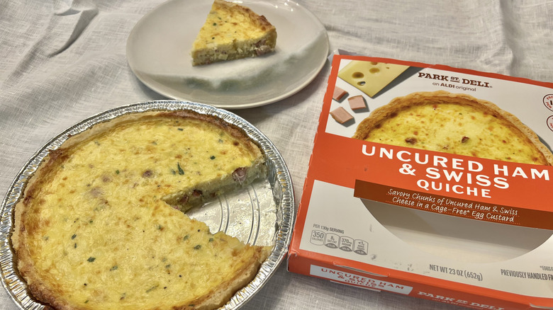 Aldi ham and Swiss quiche with slice on plate.