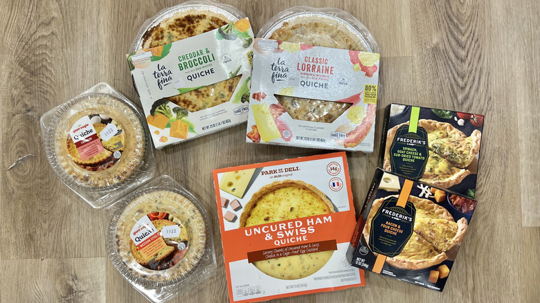 7 different store-bought quiches in boxes.