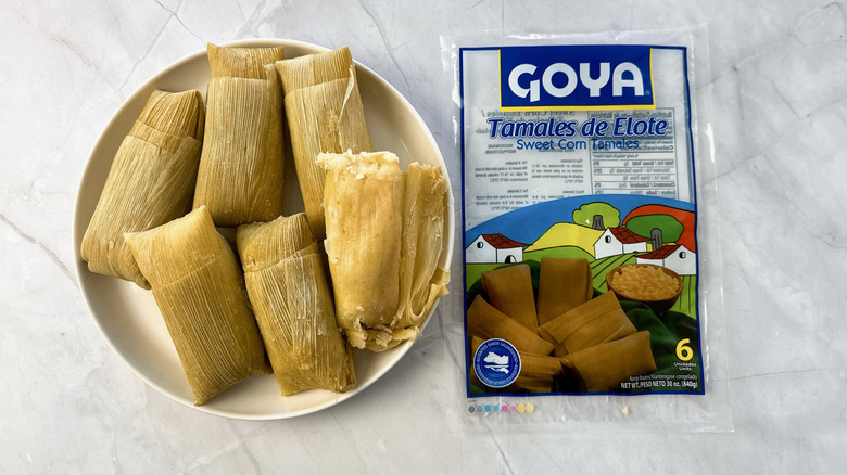 tamales on a plate with goya packaging alongside
