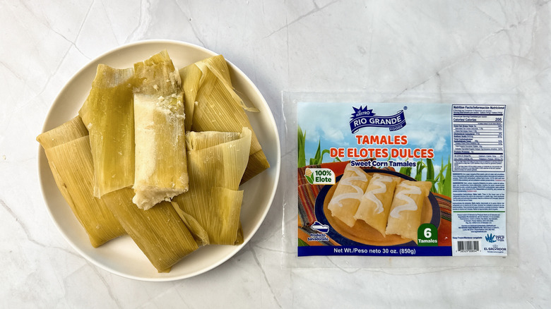 tamales on a plate with packaging alongside