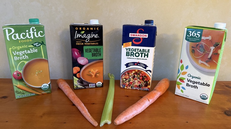 Four vegetable broths with carrots and celery between them