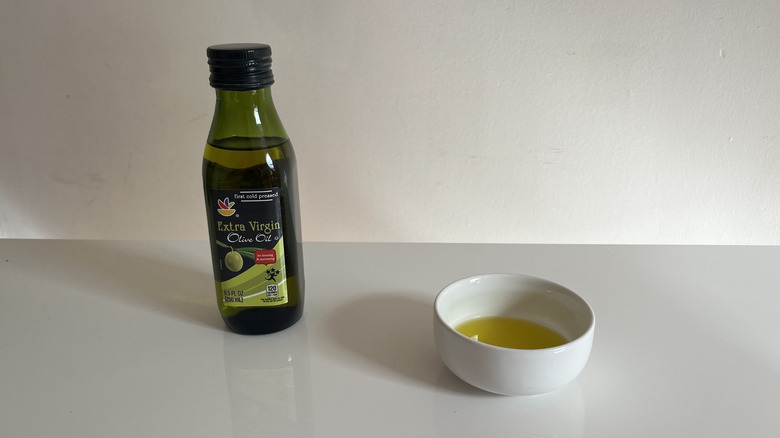 Stop & Shop olive oil with a bit poured into a little white dish beside it