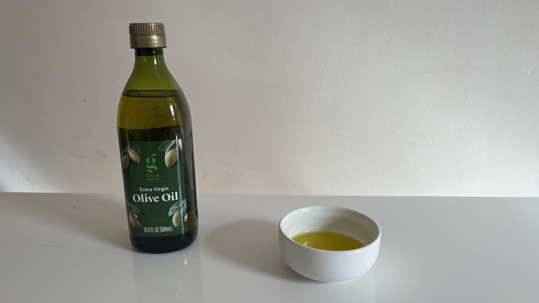 Good & Gather olive oil with a bit poured into a little white dish beside it