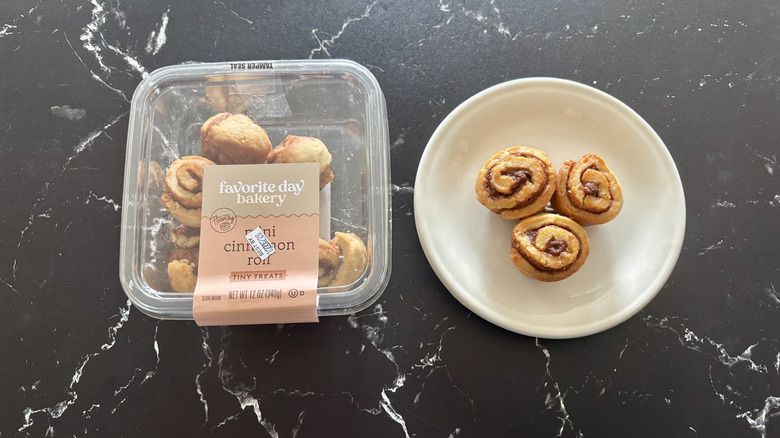 Favorite Day mini cinnamon roll container next to mini cinnamon rolls on plate