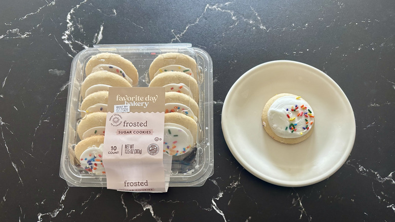 Favorite day frosted sugar cookies package next to cookie on plate