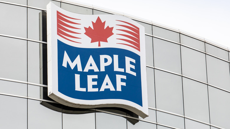 he red maple leaf logo on signs at Canadian food and meat products manufacturer Maple Leaf Canada head office building in Mississauga, Canada